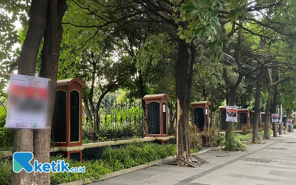 Thumbnail Penempelan baliho Capres yang melanggar aturan dengan memaku di pohon di Kawasan Depan Polda Jatim. (Foto: Shinta Miranda/Ketik.co.id)